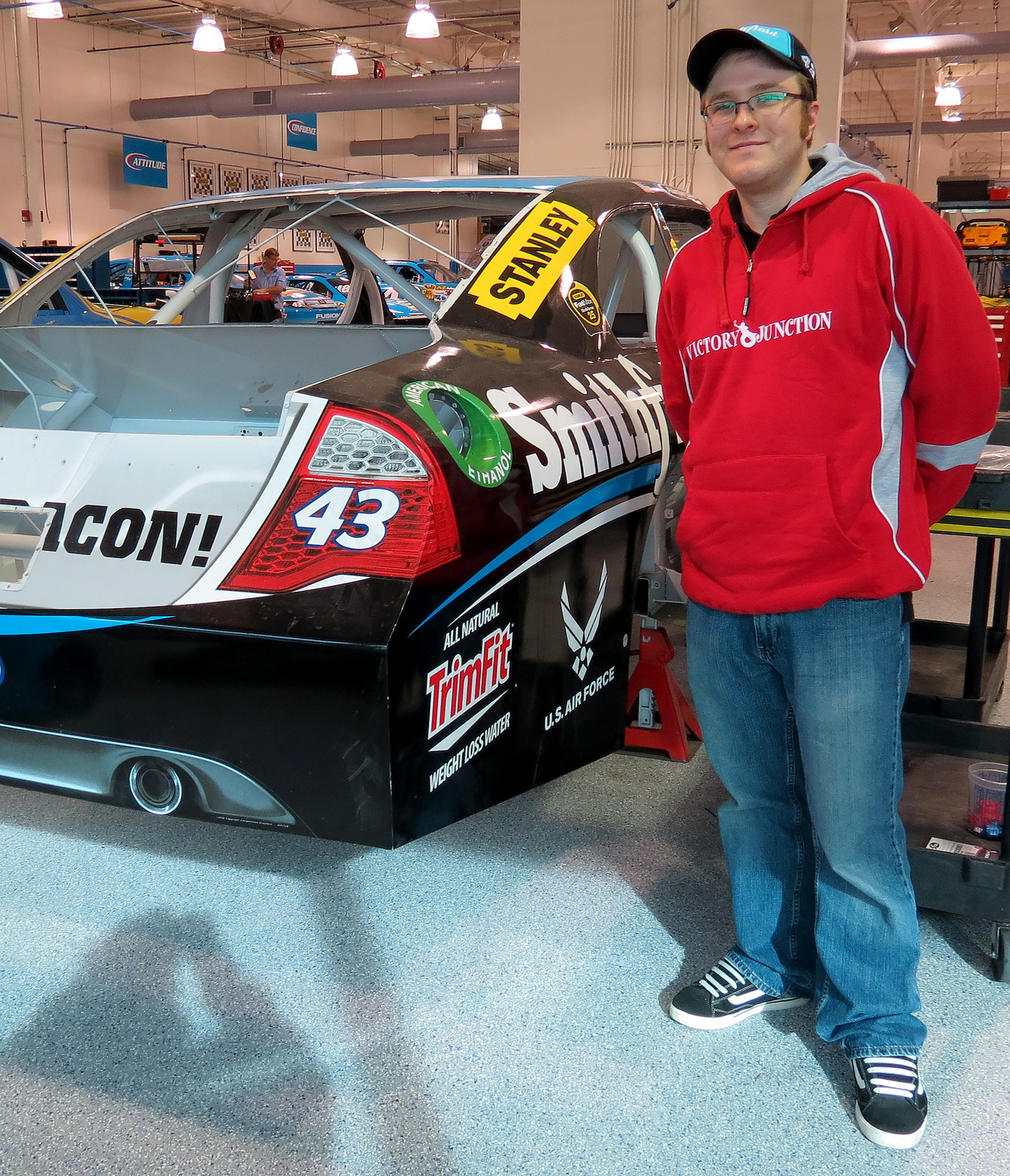 Standing with the previously raced Watkins Glen car as it sits in the Richard Petty Motorsports race shop