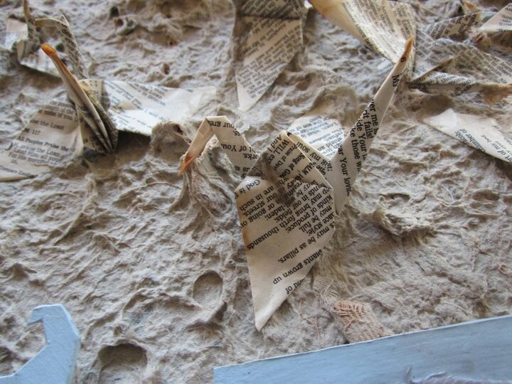 Origami birds made of Bible paper trapped in the fibers of our uniforms.