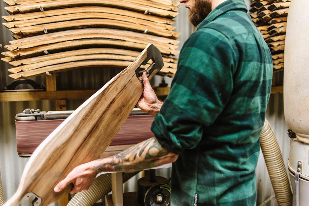 Wills Rowe in front of a stack of barrel staves 