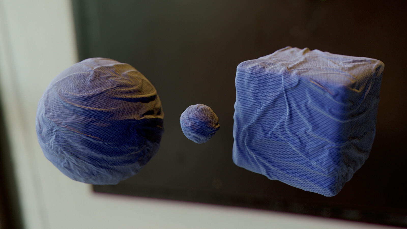 same procedural cloth material on spheres and beveled cube