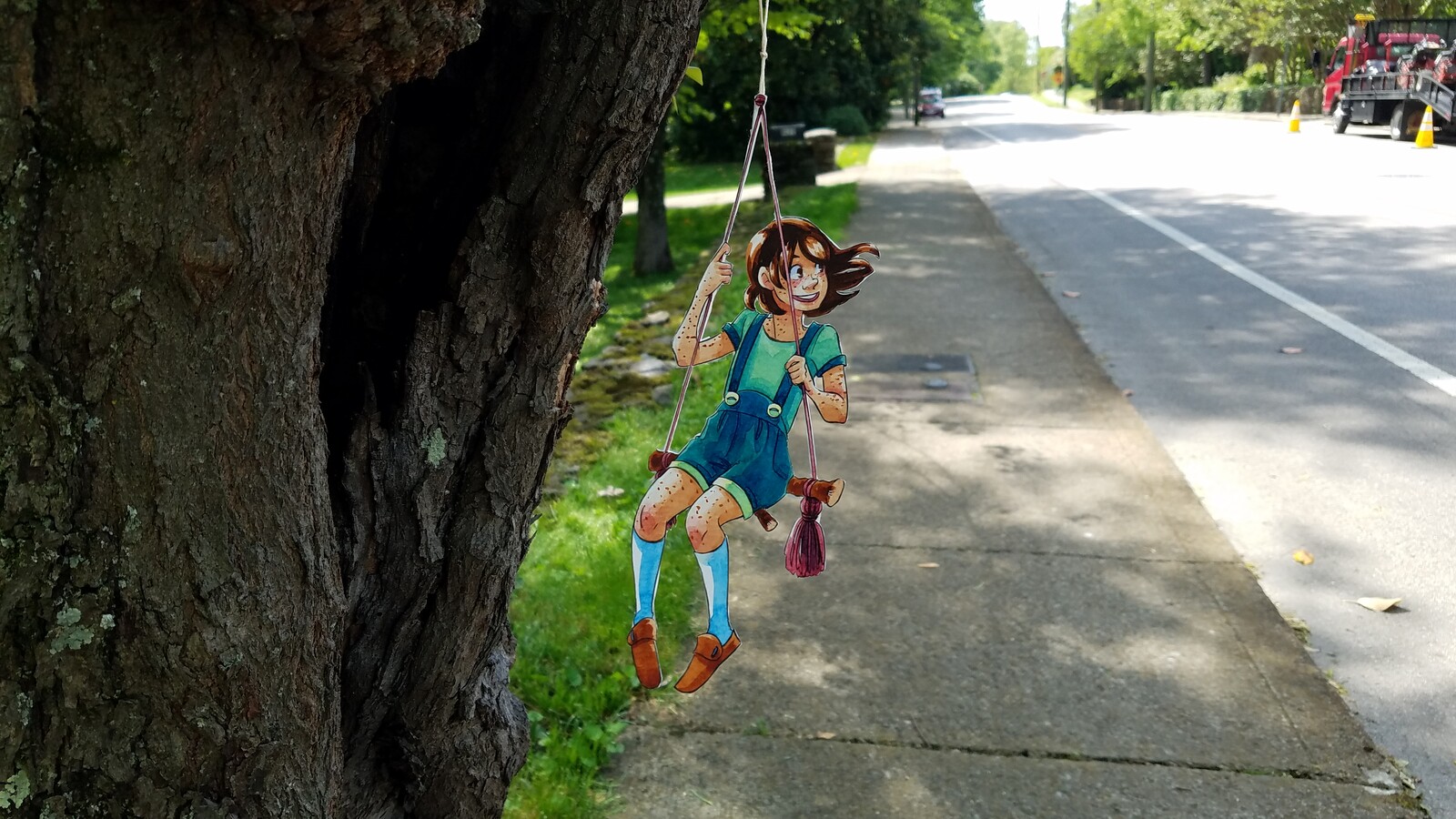 Cut paper character posed in a real world environment create an augmented reality perfect for suburban fantasy.