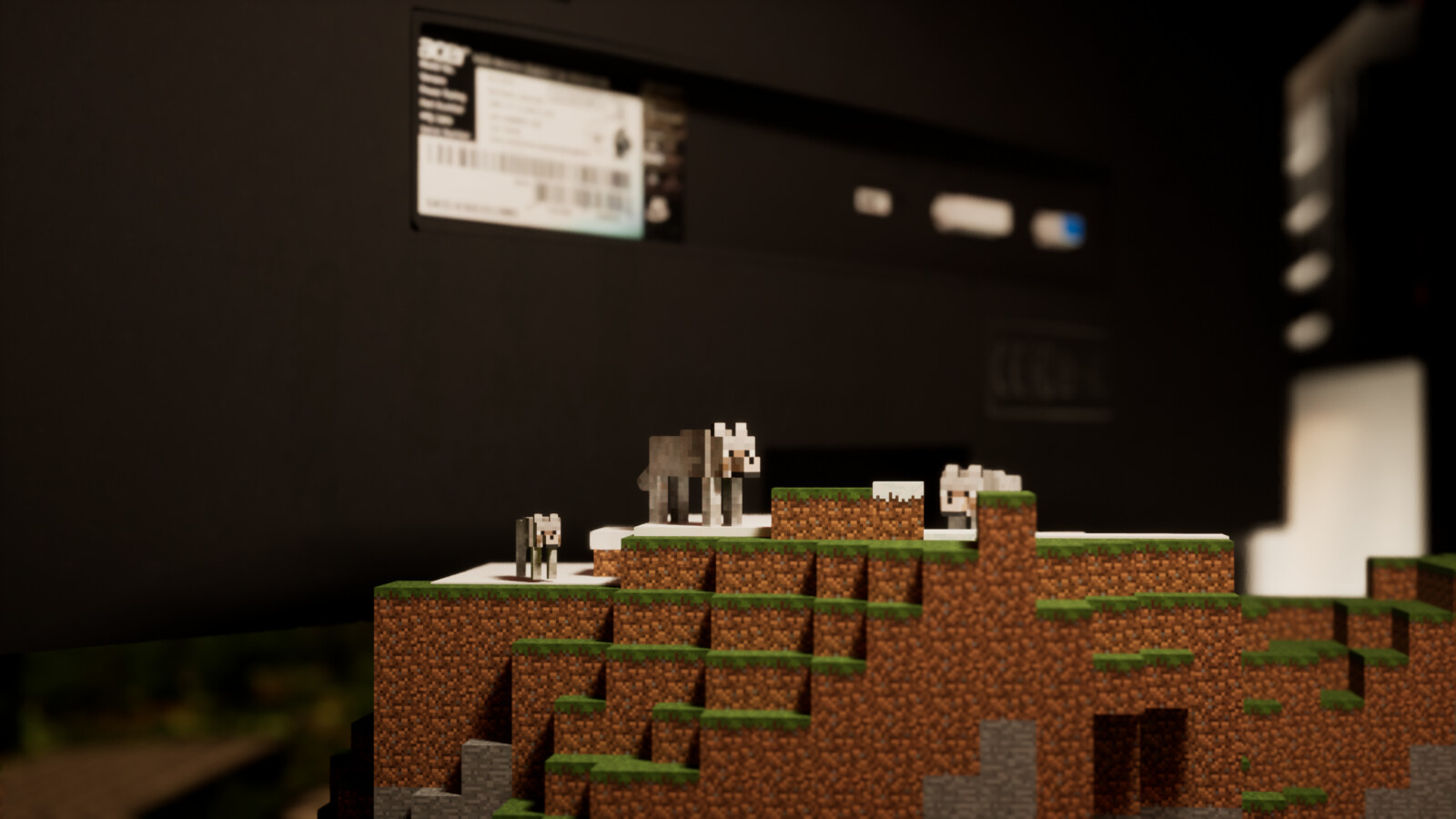 A wolf pack sits behind the monitor