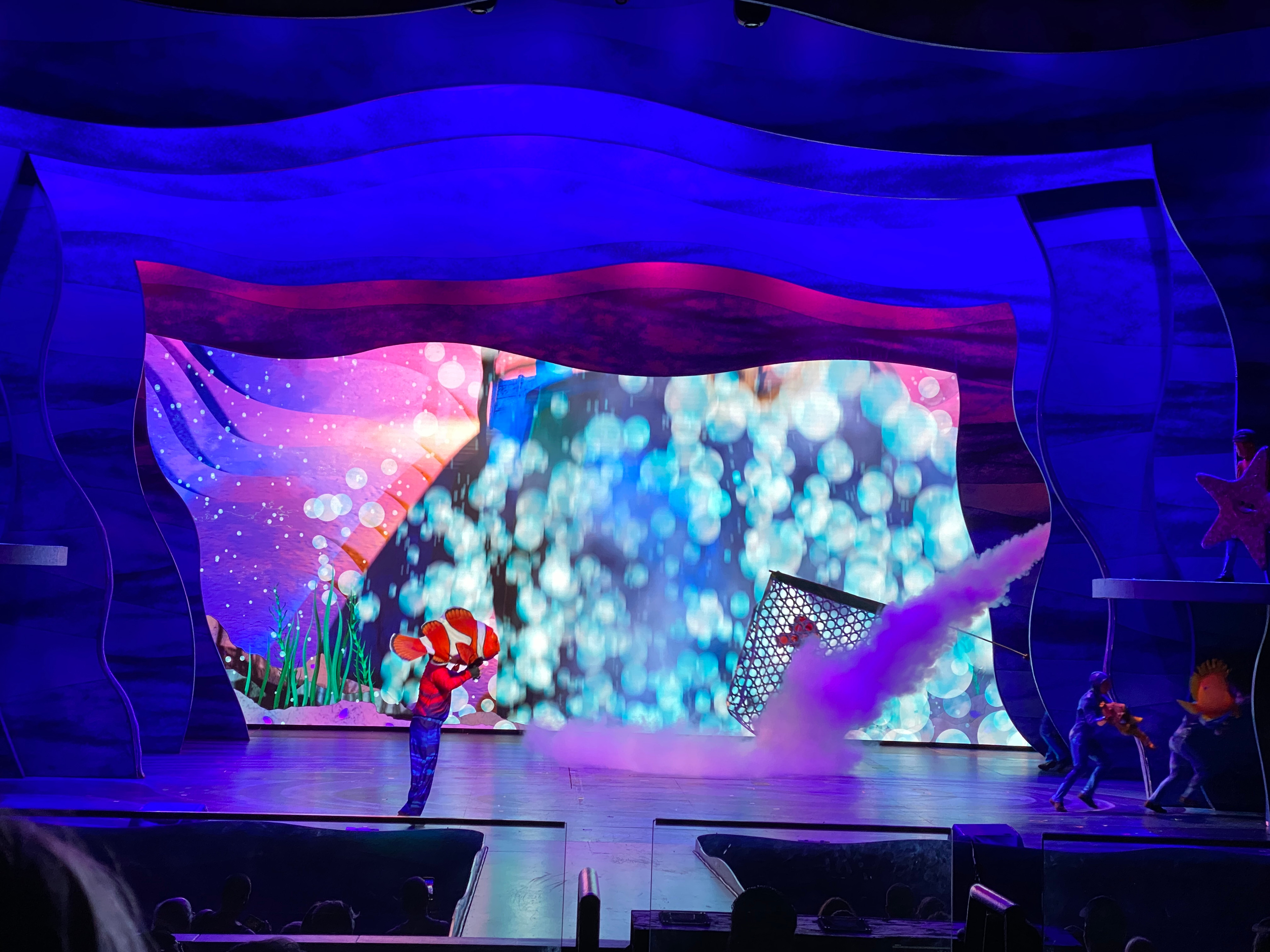 The diver leaves quickly in a flurry of bubbles as the Nemo performer goes offstage