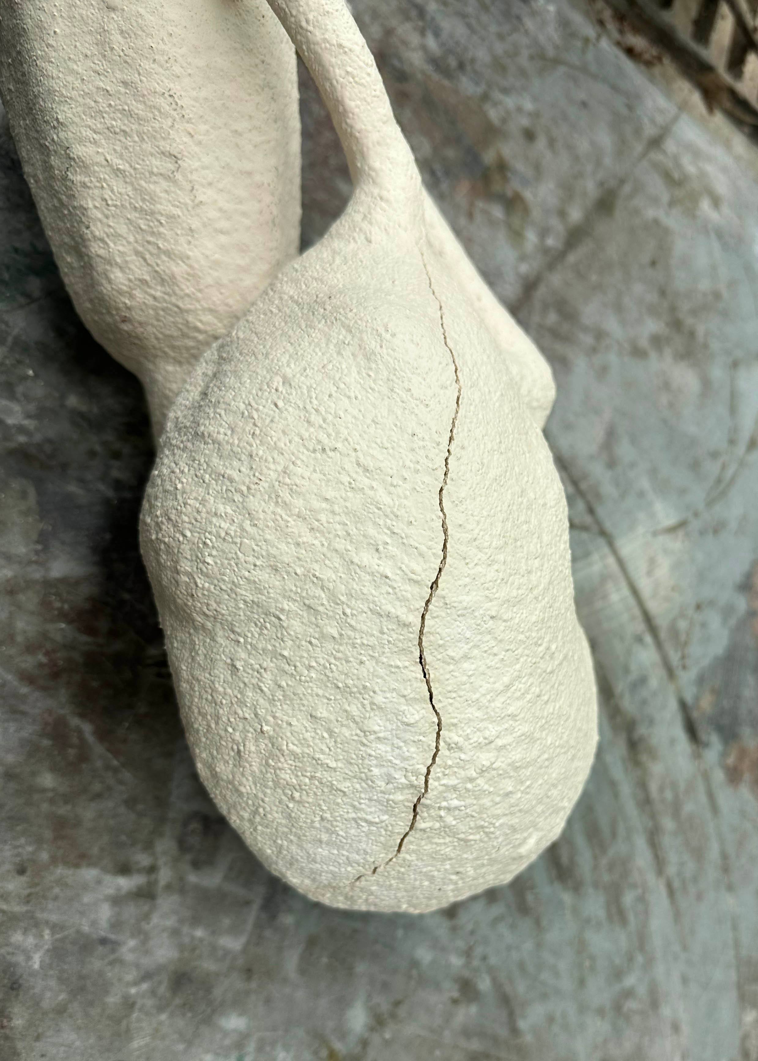 The worst part of the crack reaches up along the shoulder and neck.