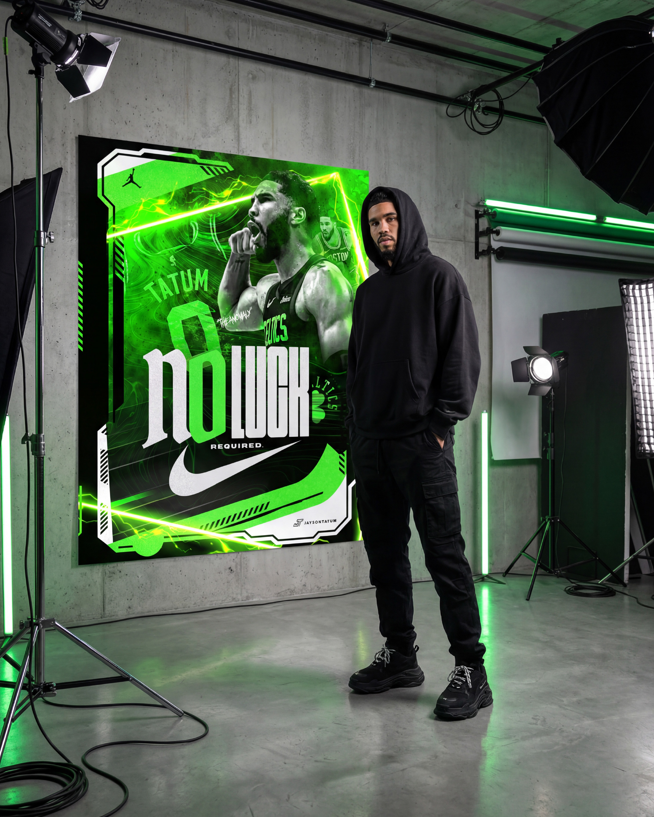 Streetwear lookbook shoot. Tatum in all black with the poster behind him, neon green light casting from the graphic onto the model and the studio floor. This is what happens when sports design crosses into fashion territory
