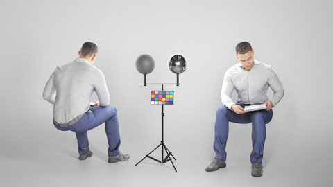 Cute young man in suit  is sitting and reading documents 180