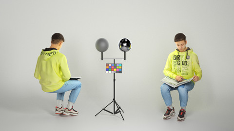 Young man sitting in chair reading book 226